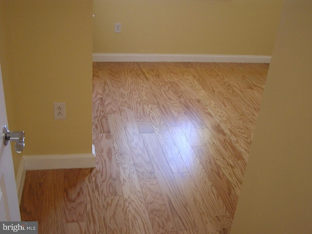 room details featuring baseboards and wood finished floors