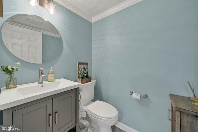 bathroom with ornamental molding, vanity, toilet, and baseboards