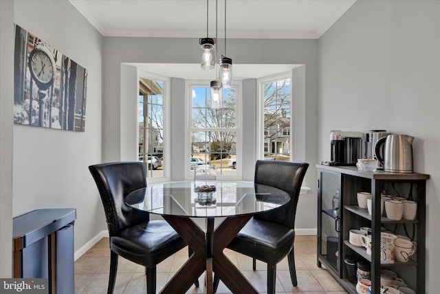 dining space with ornamental molding, baseboards, and light tile patterned floors