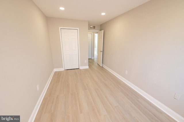 unfurnished bedroom with light wood-style floors, recessed lighting, visible vents, and baseboards