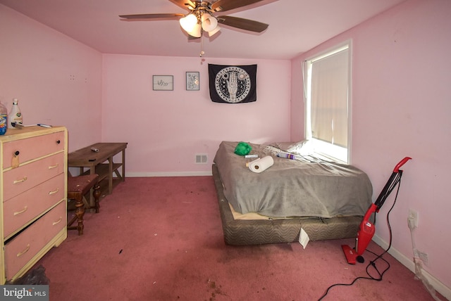 bedroom with ceiling fan, carpet floors, visible vents, and baseboards