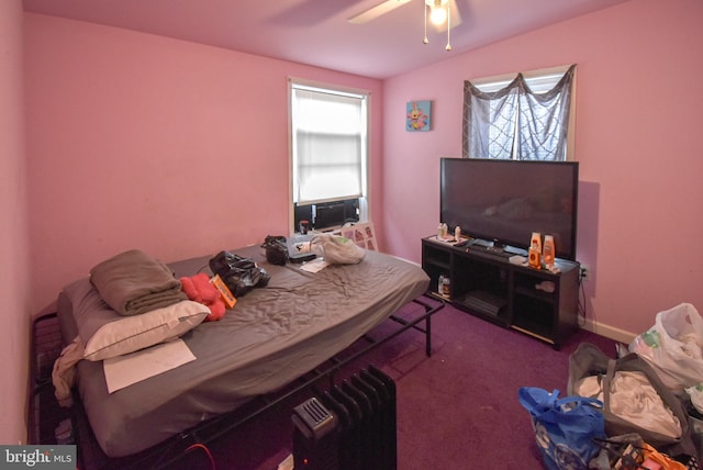 carpeted bedroom with a ceiling fan and baseboards