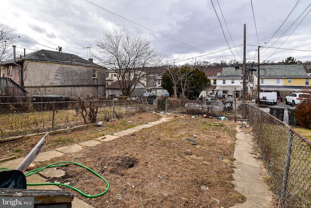 view of yard featuring a residential view and fence