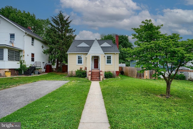 bungalow-style home with a chimney and roof with shingles