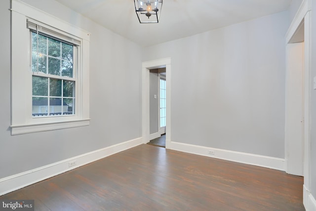 unfurnished room with wood finished floors and baseboards