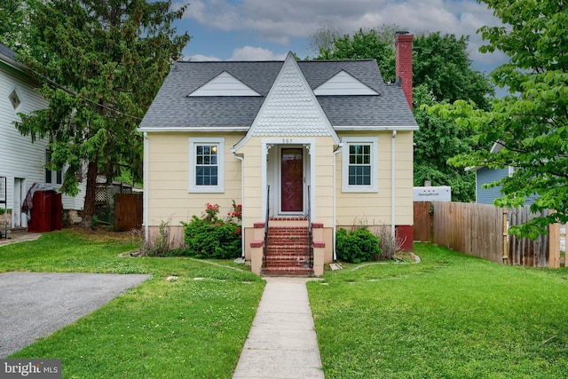 view of front of property with roof with shingles and a chimney