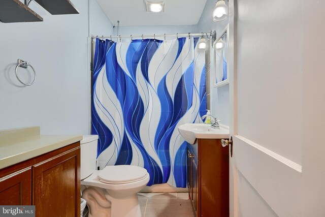 bathroom with vanity, toilet, tile patterned flooring, and curtained shower