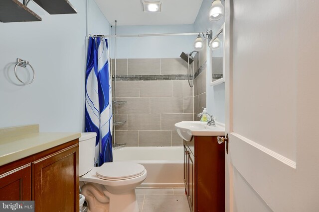 bathroom featuring vanity, shower / bath combo with shower curtain, toilet, and tile patterned flooring
