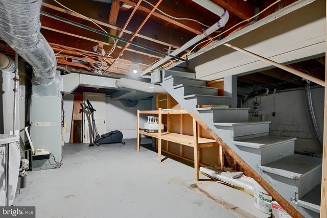 unfinished below grade area with stairs and heating unit
