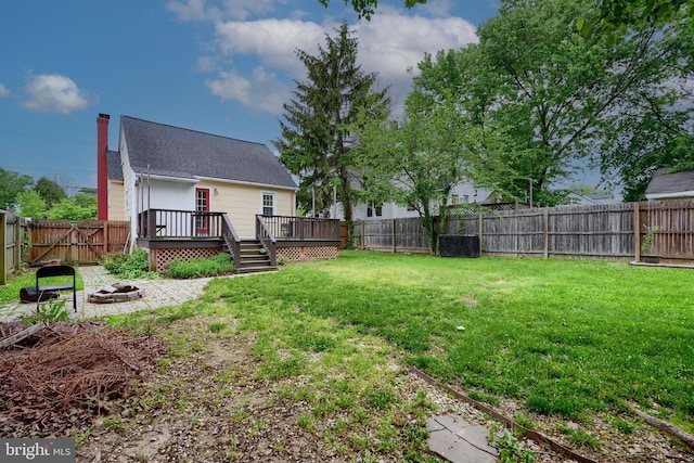view of yard featuring an outdoor fire pit and a deck