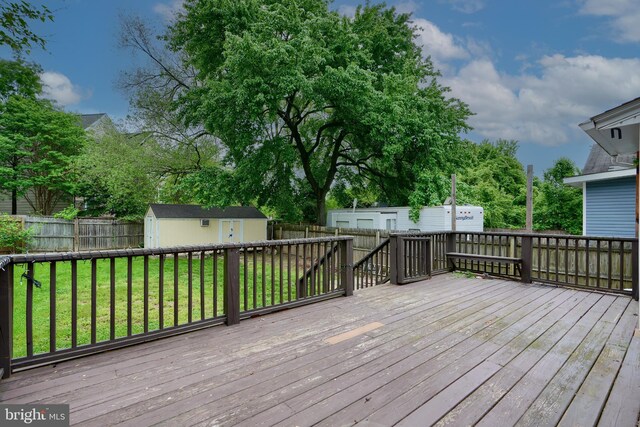 deck with a storage unit and an outdoor structure