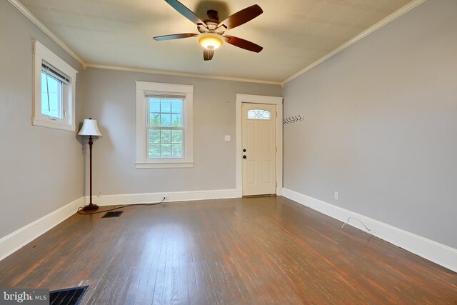 foyer featuring dark wood-type flooring, baseboards, a ceiling fan, and ornamental molding