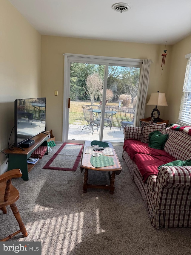 carpeted living room with visible vents