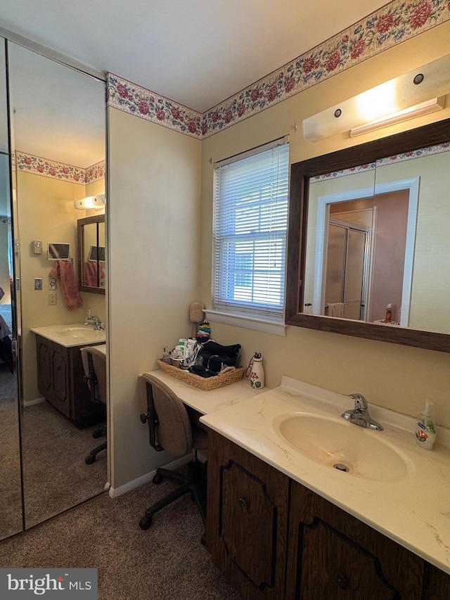 full bath with a shower stall, vanity, and baseboards