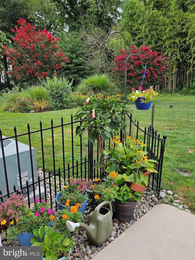 view of yard featuring fence and a garden