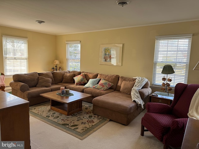 living room with visible vents, crown molding, and light colored carpet