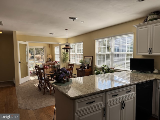 kitchen with visible vents, dishwasher, hardwood / wood-style flooring, a peninsula, and white cabinetry