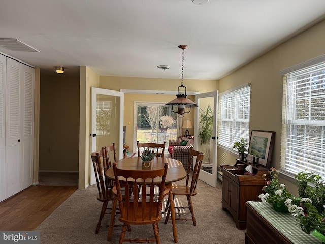 dining room with light wood-type flooring and visible vents