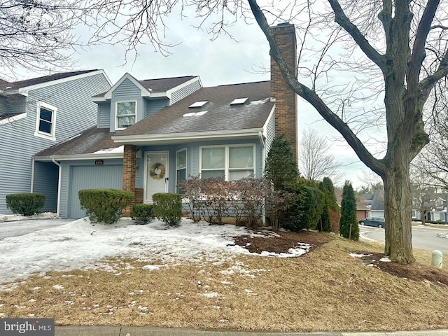 view of front of house with a garage, roof with shingles, and a chimney