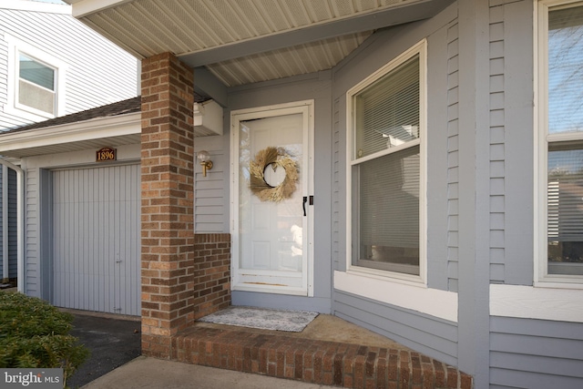 doorway to property with brick siding