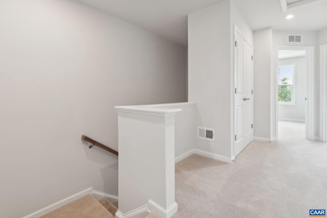 staircase featuring carpet floors, baseboards, and visible vents