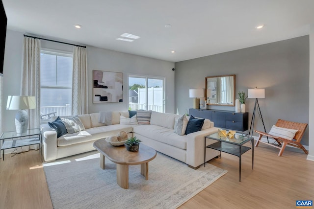 living area featuring light wood finished floors and recessed lighting