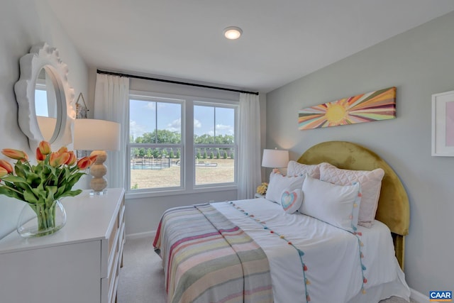 bedroom featuring carpet and baseboards