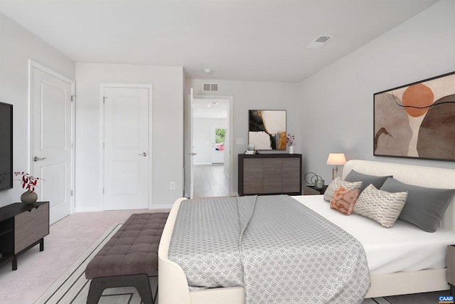 carpeted bedroom featuring visible vents