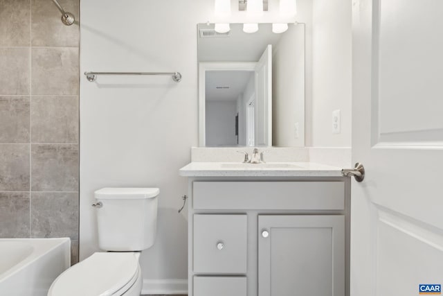 bathroom with toilet, visible vents, and vanity