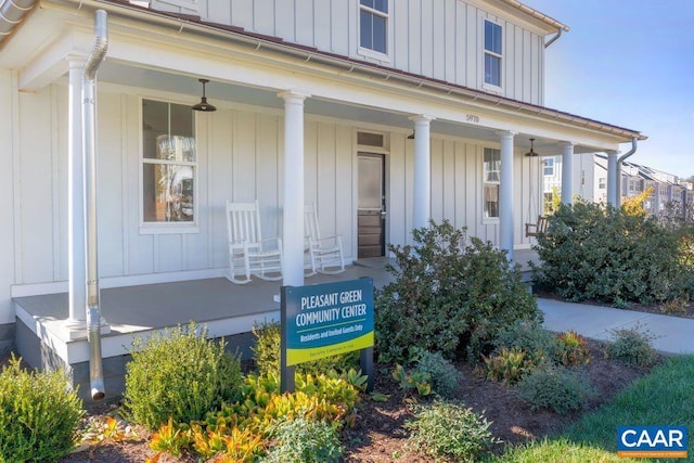 property entrance featuring covered porch and board and batten siding