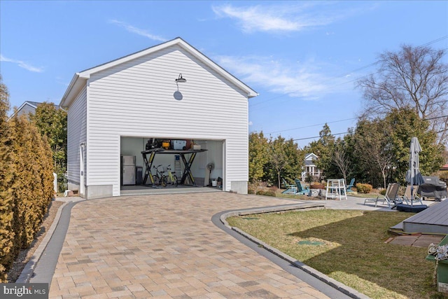 garage with decorative driveway