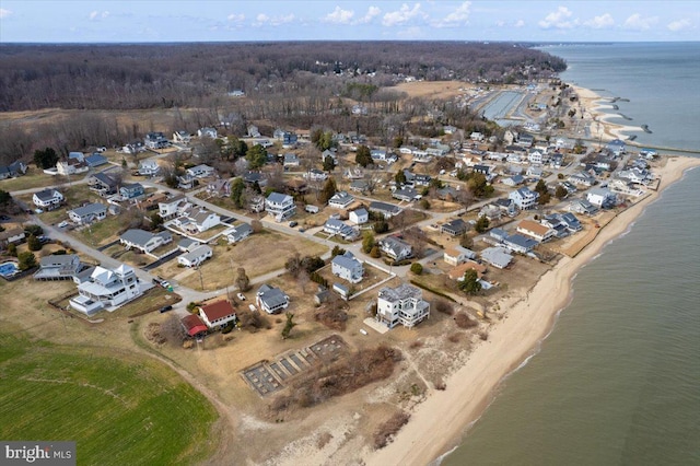 birds eye view of property featuring a water view and a beach view