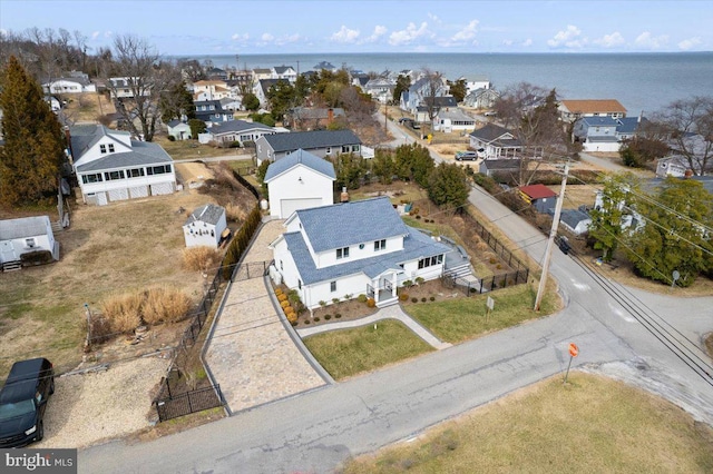 bird's eye view with a residential view and a water view