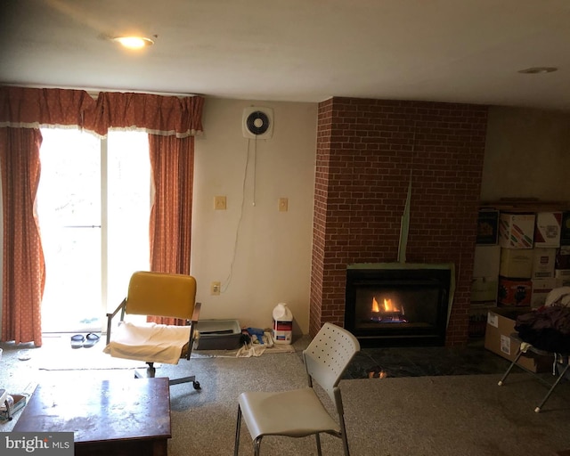 living area featuring a fireplace, carpet flooring, and visible vents