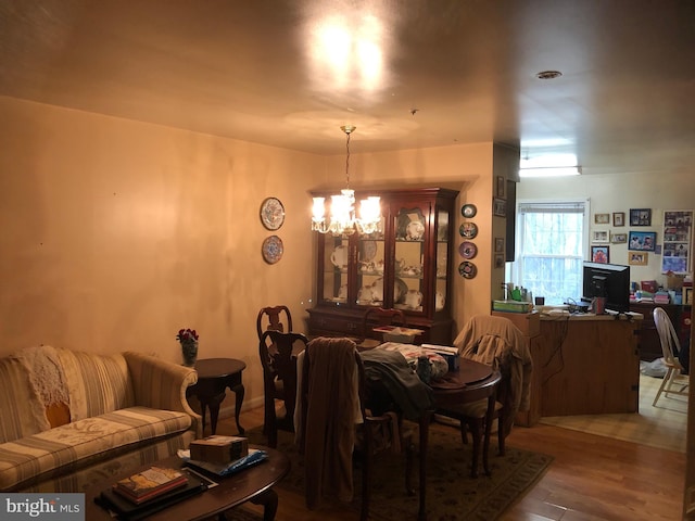 dining area with an inviting chandelier and wood finished floors