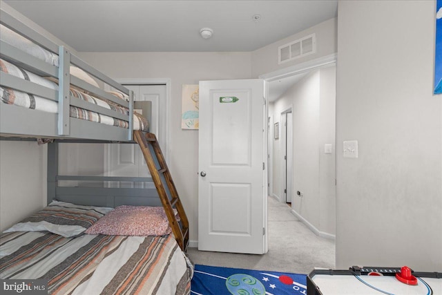 bedroom with a closet, visible vents, baseboards, and carpet