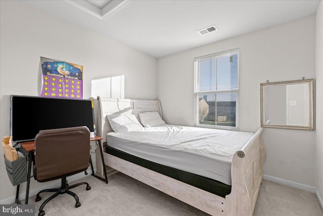 carpeted bedroom featuring visible vents and baseboards