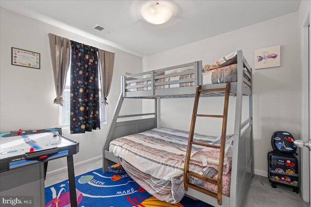 carpeted bedroom with visible vents and baseboards