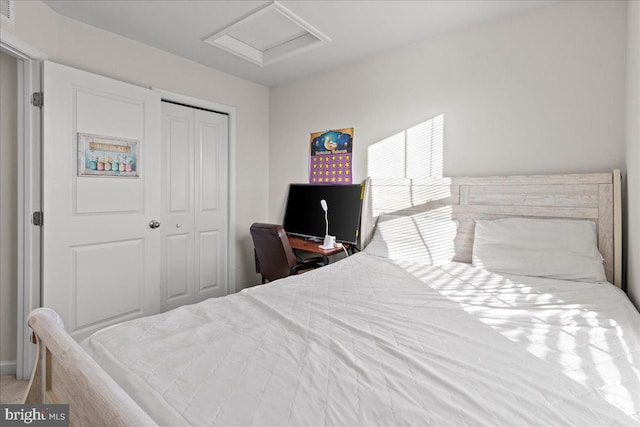 bedroom featuring attic access and a closet