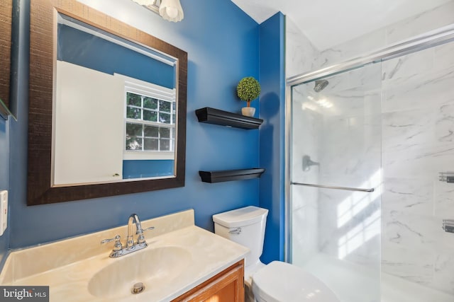 full bathroom featuring a marble finish shower, toilet, and vanity