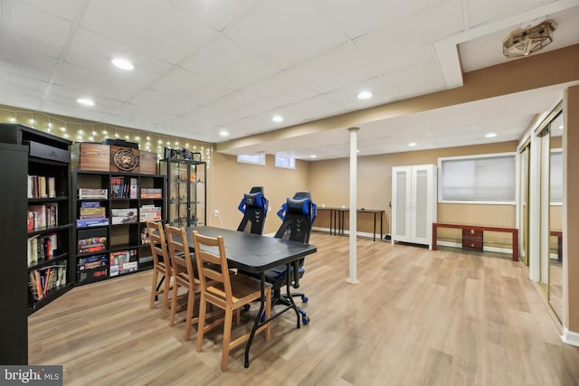 dining space with recessed lighting, wood finished floors, baseboards, and a paneled ceiling