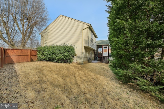 view of side of home with fence