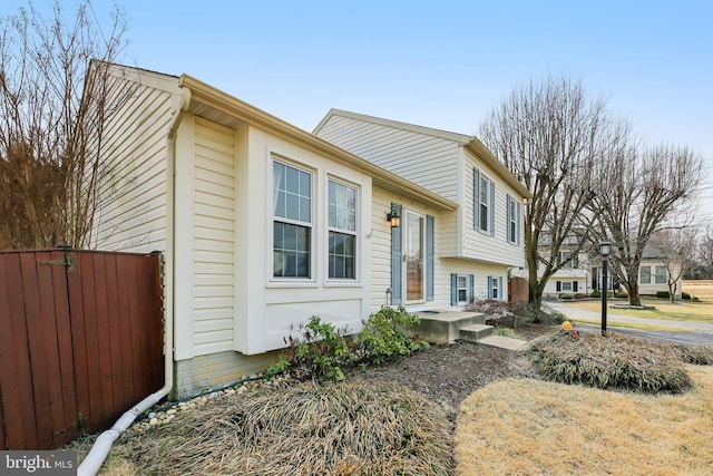 split level home with fence