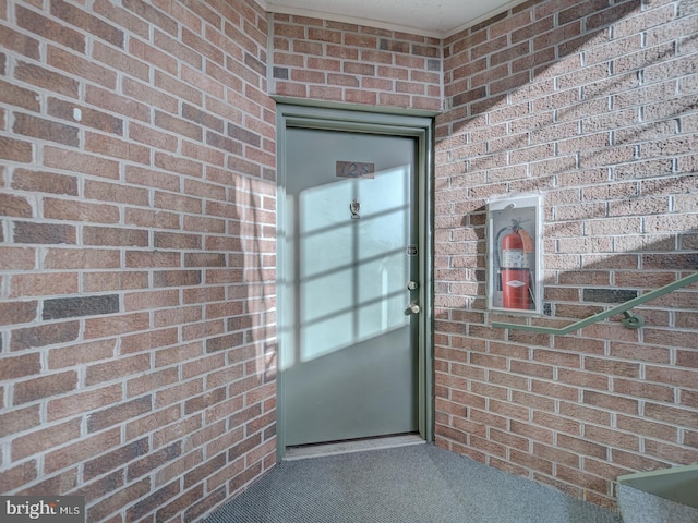 property entrance with brick siding