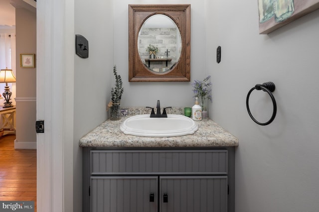 bathroom with wood finished floors and vanity