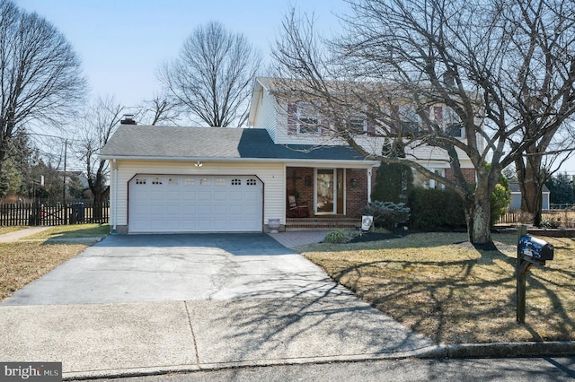 traditional-style home featuring driveway, an attached garage, fence, a front lawn, and brick siding