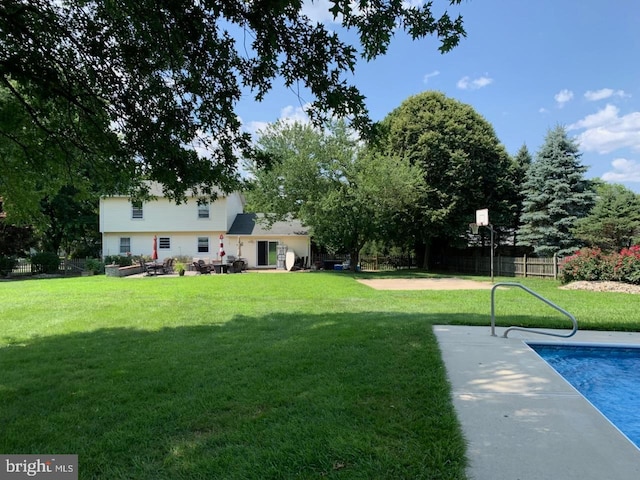 view of yard featuring a patio, fence, and a fenced in pool