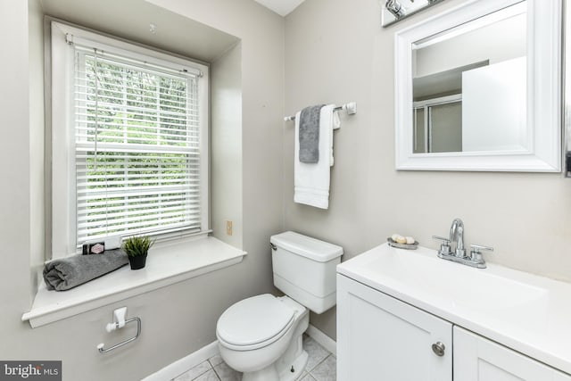 full bath with toilet, a shower with door, baseboards, and vanity