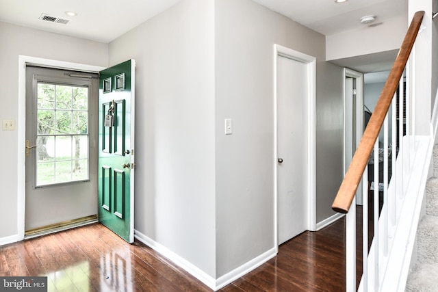 foyer entrance with stairs, wood finished floors, visible vents, and baseboards