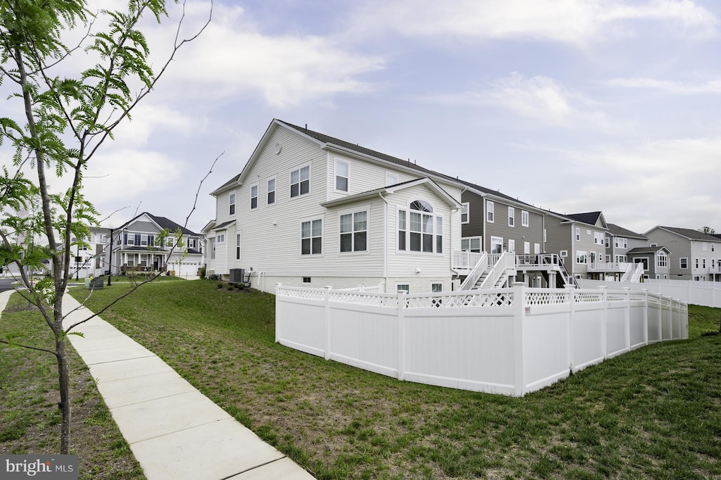 view of side of property featuring a residential view and central air condition unit